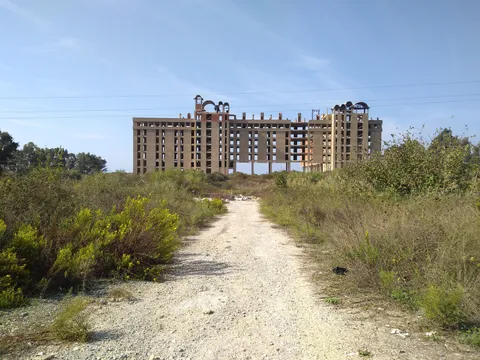 An abandoned hotel ruin along the seaside