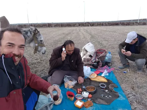Having lunch with a shepherd. As usual, everybody is on their phone (including me, to take this photo!)