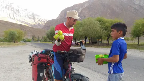 This boy was the first in a line of a few dozens selling apples on the street.