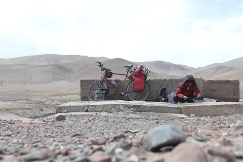 Cooking lunch at the roadside before taking on the last pass to Kyrgyzstan