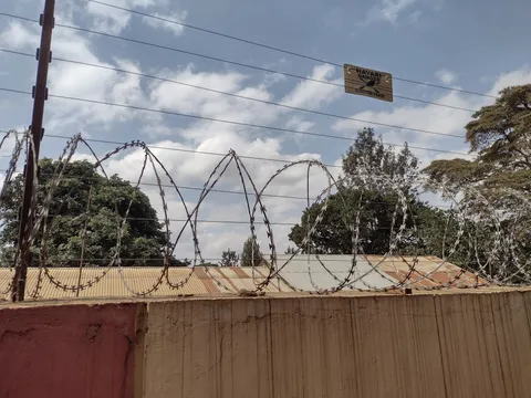 Not a high security prison, but just a regular house with a wall, barbwire and electrical fencing
