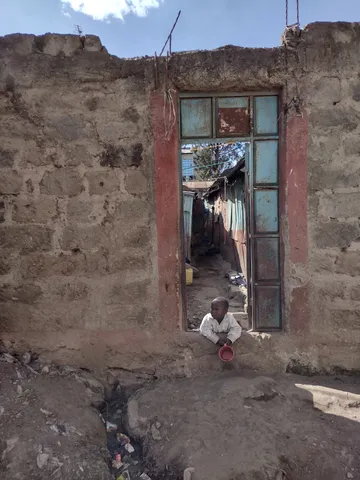 Child looking out of an alleyway